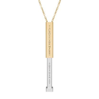 Gold and silver necklace with engraved name on a white background