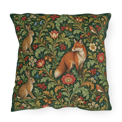 A square decorative throw pillow featuring a classic William Morris-style floral pattern with a fox, rabbits, and birds on a dark green background.