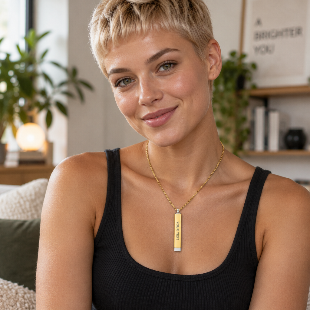 Gold tone personalized sliding bar necklace worn with black sleeveless top