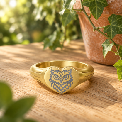 Close-up of engraved owl heart signet ring in 18K gold PVD finish