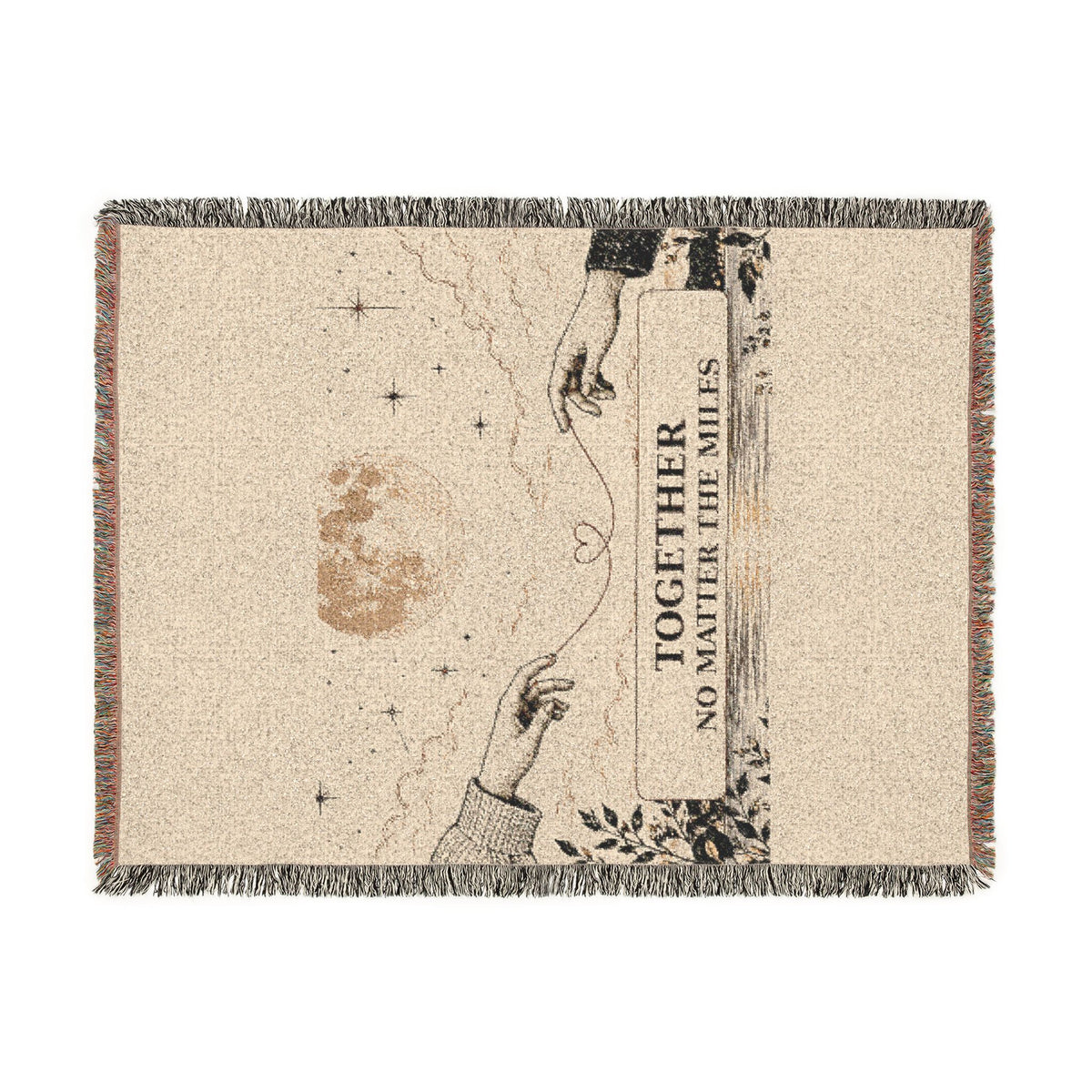 A rectangular woven throw blanket with fringe on all sides, featuring a beige background and a printed design of two reaching hands, stars, a moon, and the text 'TOGETHER NO MATTER THE MILES'.