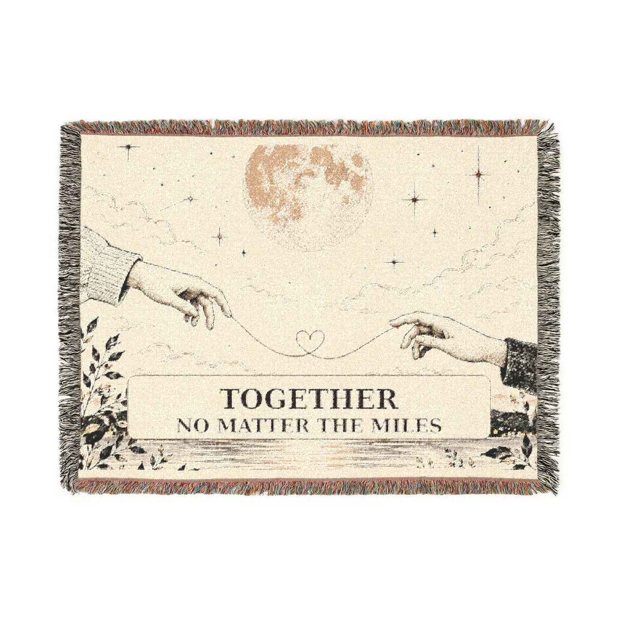 A square woven throw blanket with fringe edges, featuring an illustration of two hands reaching toward a heart, a moon, stars, and the text 'TOGETHER NO MATTER THE MILES' on a cream background.