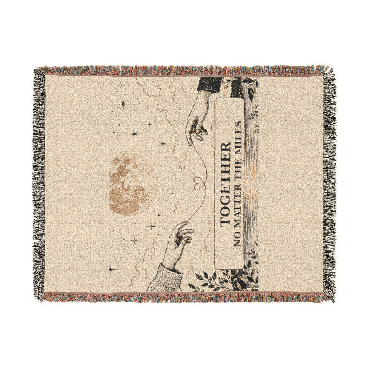 A rectangular woven throw blanket with fringed edges, featuring a beige textured background and a printed illustration of two reaching hands, stars, a moon, and the text 'TOGETHER NO MATTER THE MILES'.