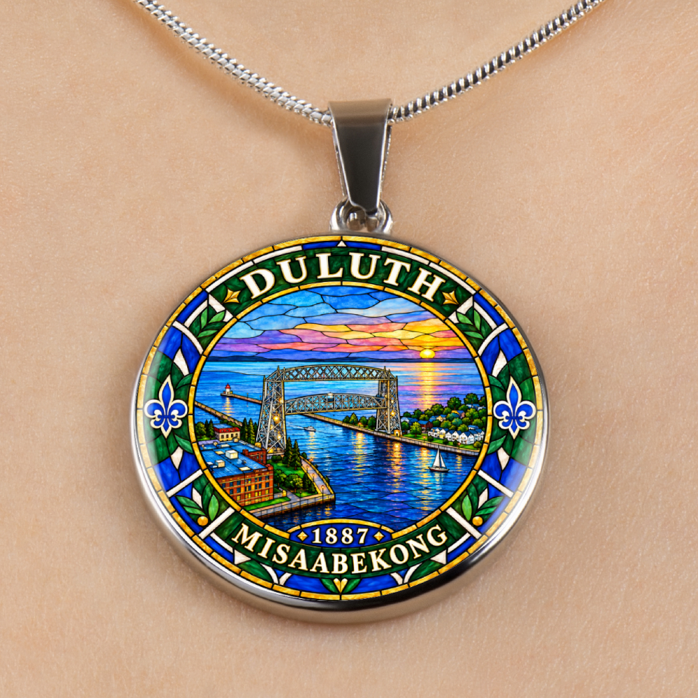 Silver Duluth Minnesota necklace featuring colorful stained-glass artwork of the Aerial Lift Bridge, Lake Superior, sunset sky and ornamental border on human skin