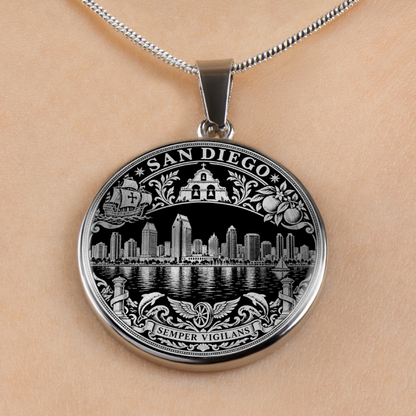 A silver-toned round pendant necklace featuring an engraved San Diego skyline design with the words 'SAN DIEGO' and 'SEMPER VIGILANS', shown worn on a person's neck against a light skin tone background.