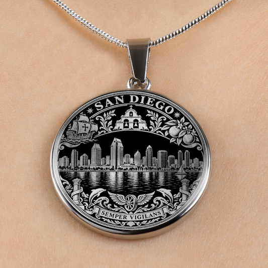 A silver-toned round pendant necklace featuring an engraved San Diego skyline design with the words 'SAN DIEGO' and 'SEMPER VIGILANS', shown worn on a person's neck against a light skin tone background.