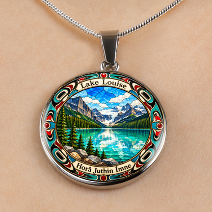 Silver Lake Louise Alberta necklace featuring turquoise glacial lake, snow-covered Canadian Rockies, evergreen forest and colorful stained-glass border on a fair skin toned background.