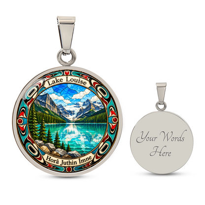 Silver finish Lake Louise pendant necklace showing bright blue mountain lake, snowy peaks, pine trees and decorative stained-glass artwork with engraving option.