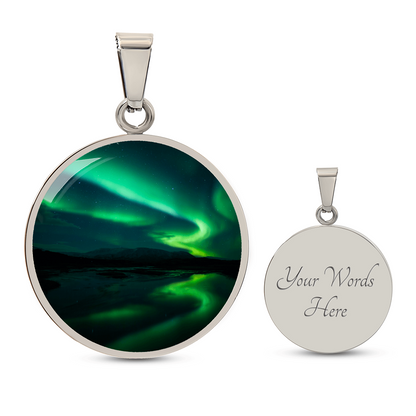 Green Aurora Northern Lights necklace featuring vivid emerald aurora ribbons above dark mountains on a round silver-colored pendant with personalized text