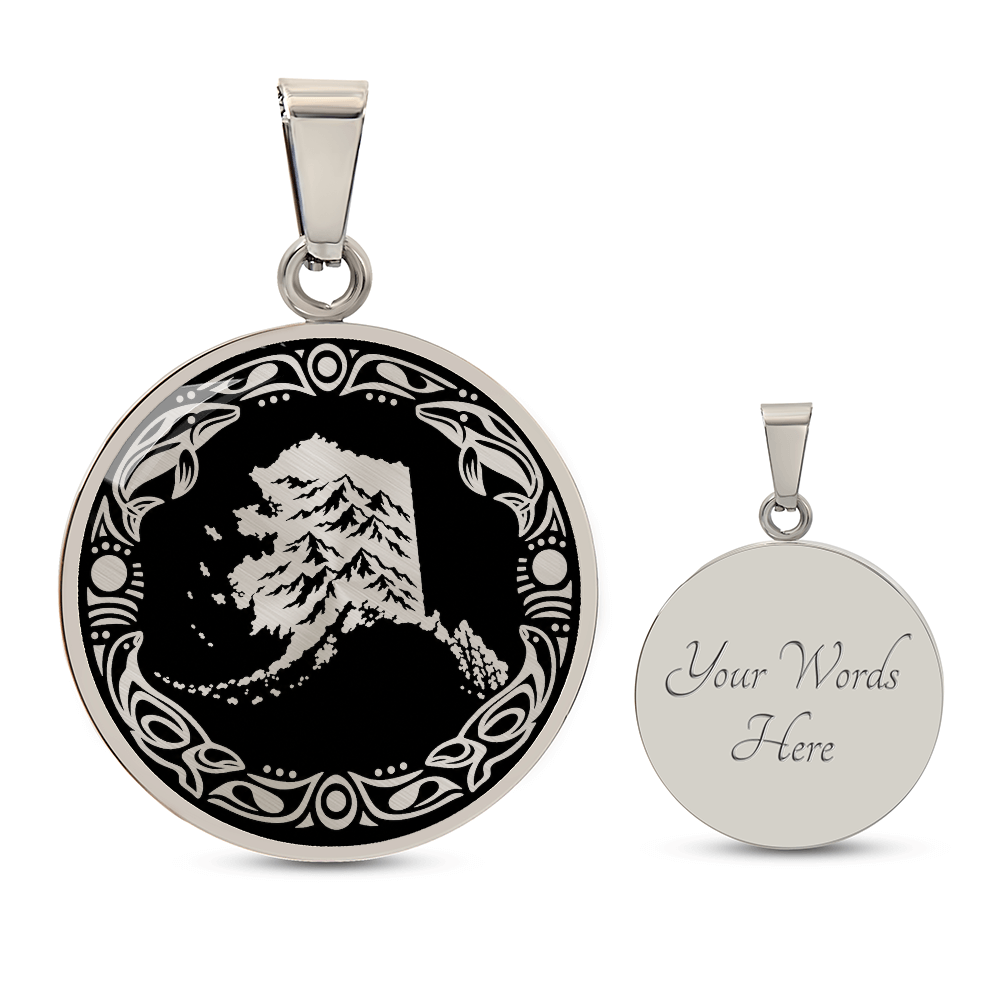silver finish Alaska mountain necklace with dramatic snowy peak illustration, black and gold linocut design and decorative border. Engraving option