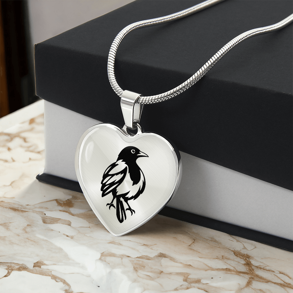 Heart shaped magpie necklace with linocut-inspired bird artwork