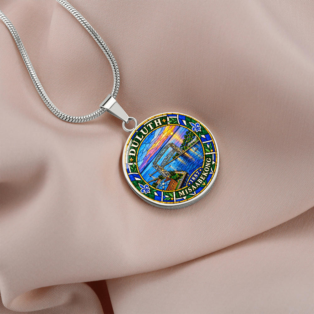 Silver Duluth Minnesota necklace featuring colorful stained-glass artwork of the Aerial Lift Bridge, Lake Superior, sunset sky and ornamental border