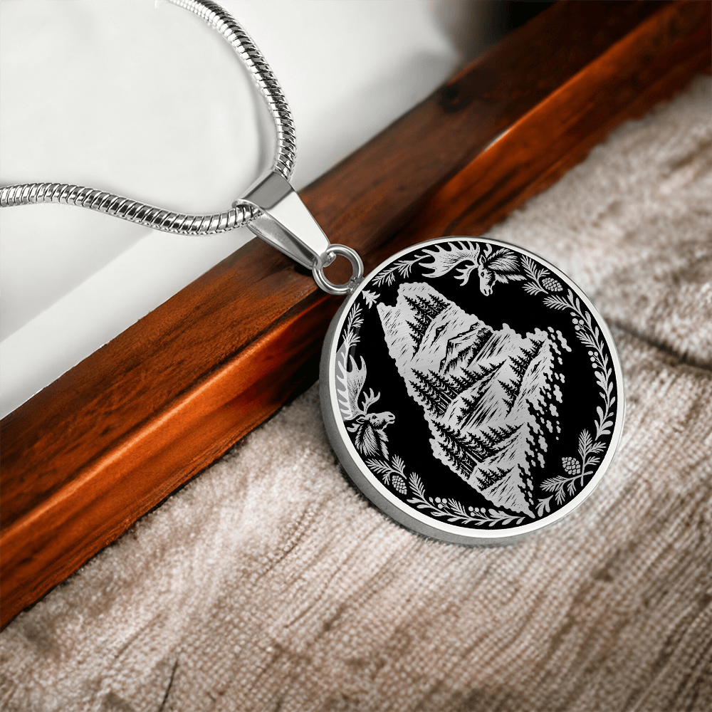 Silver Maine moose necklace featuring Maine state outline with mountain forest landscape, two moose and pinecone woodland border