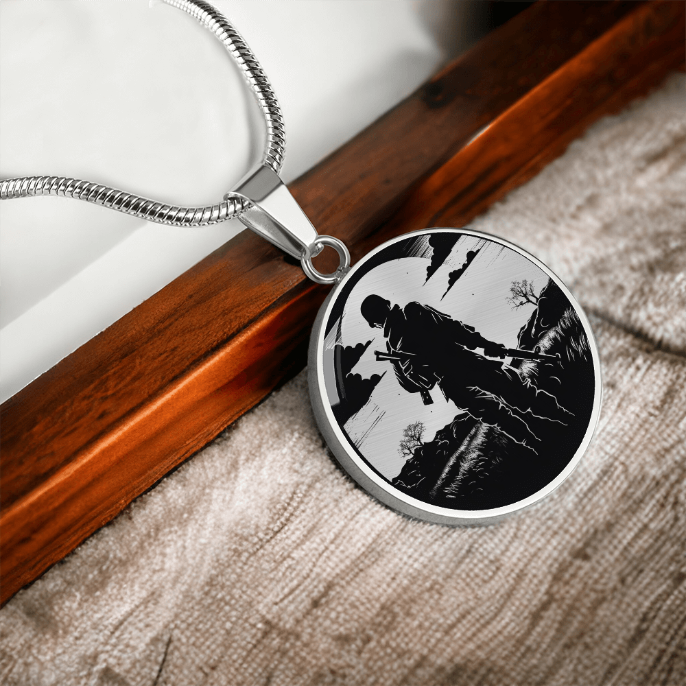 Soldier silhouette necklace with black-and-white illustration of an armed service member walking through a rugged landscape on a round pendant.