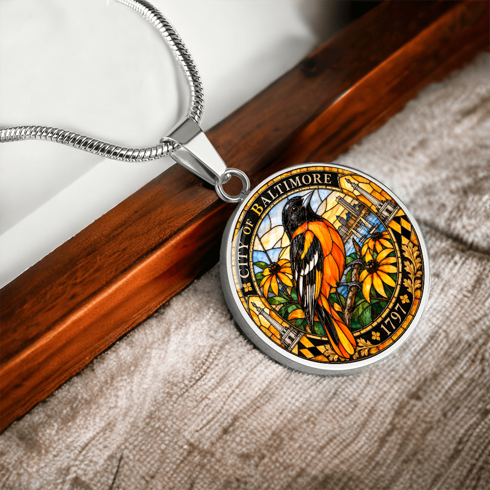Silver Baltimore Oriole necklace with orange and black stained-glass bird, golden flowers, City of Baltimore lettering and 1797 inscription