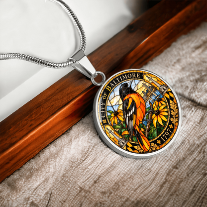 Silver Baltimore Oriole necklace with orange and black stained-glass bird, golden flowers, City of Baltimore lettering and 1797 inscription