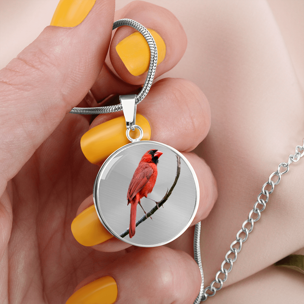 female holding a Silver-colored Northern Cardinal pendant necklace featuring lifelike red bird portrait artwork.