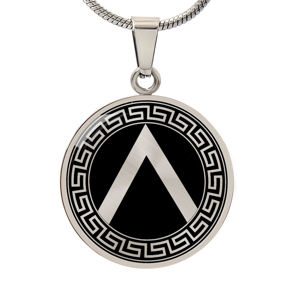 Silver Spartan shield necklace featuring ancient Greek warrior shield artwork on a circular pendant.