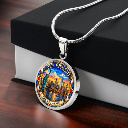 New York City skyline necklace in silver finish with Manhattan skyscrapers, One World Trade Center, Brooklyn Bridge and colorful sunset with black and white gift box.