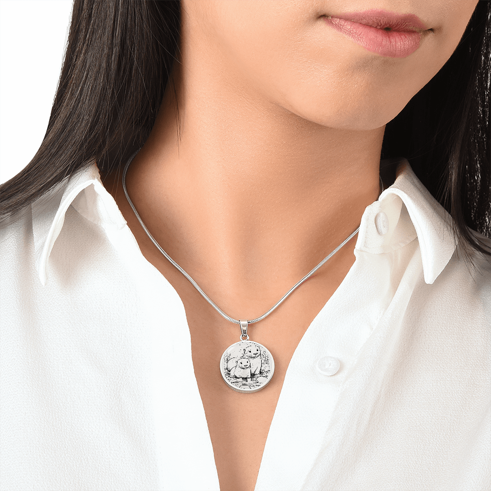 Sea Otter Couple Necklace featuring two otters together in a delicate black-and-white shoreline illustration on a silver-colored pendant.