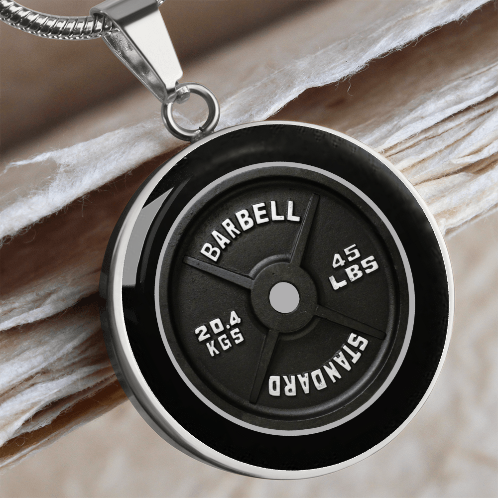 45 lb weight plate necklace with realistic black barbell plate artwork and 45 LBS 20.4 KGS markings on a round pendant.