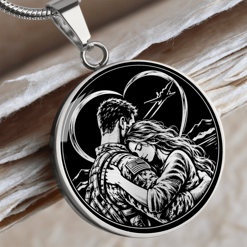 Silver military couple necklace with black and white illustration of a man in military-style clothing embracing a woman, with an aircraft overhead.