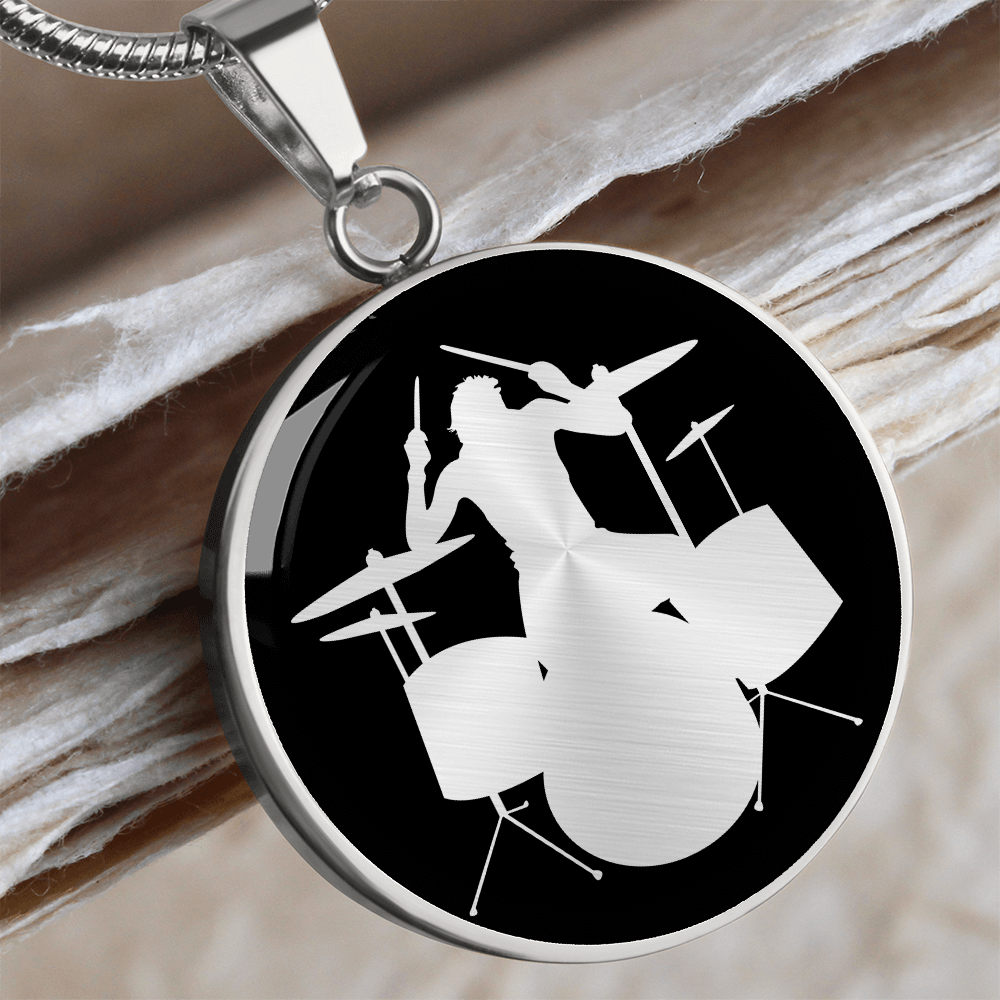Silver Drum kit necklace featuring a silver drummer silhouette playing an acoustic drum set against a black circular pendant background.