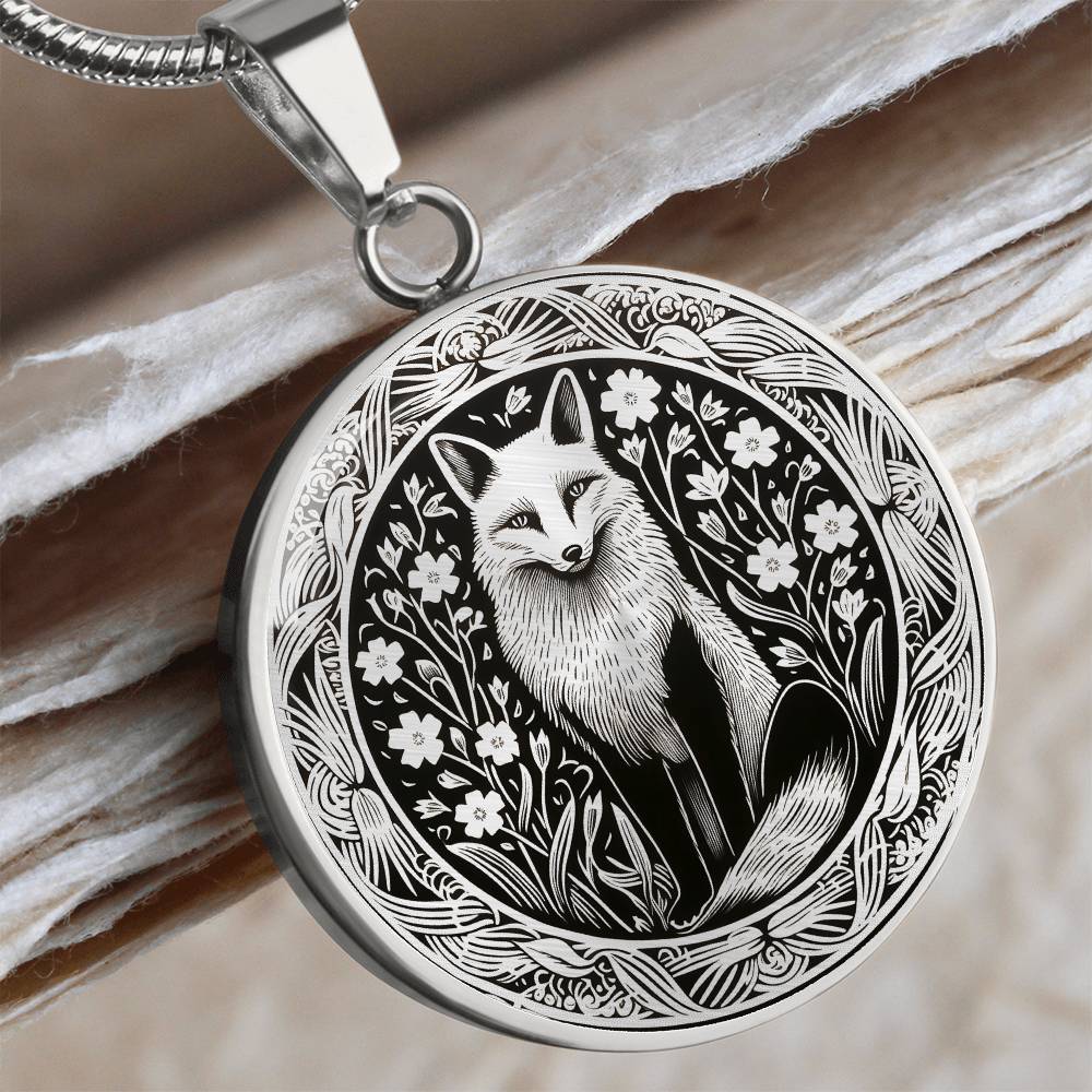 Silver-colored fox pendant necklace with detailed monochrome woodland fox and floral illustration.