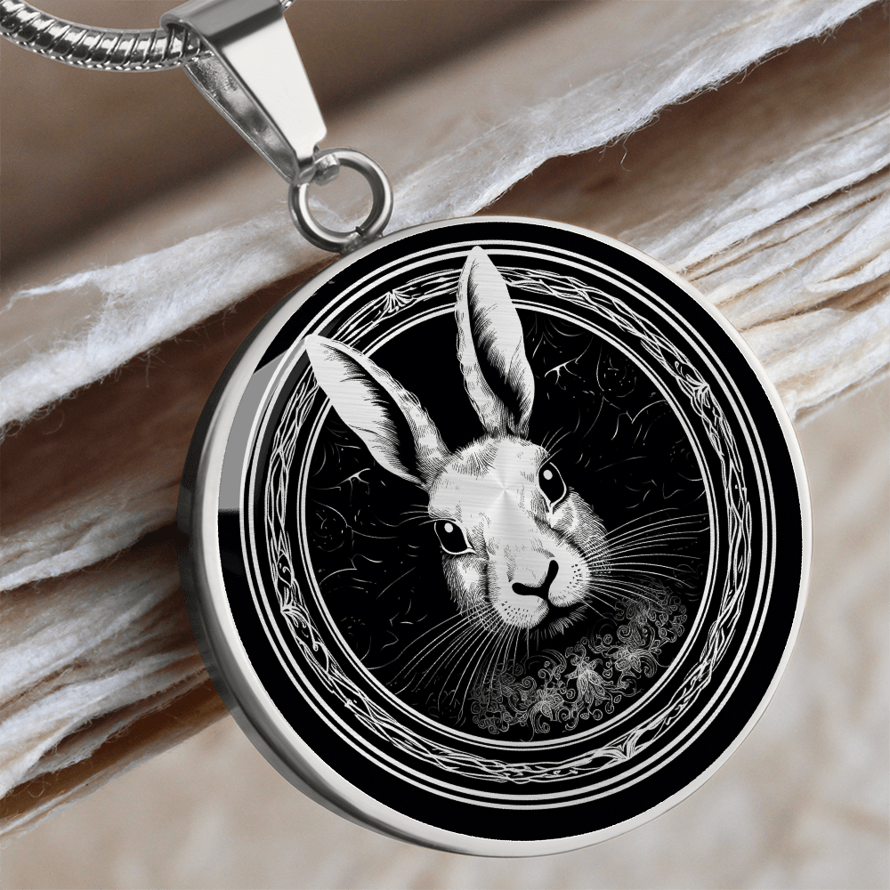 Silver William Morris-inspired rabbit necklace featuring a black-and-white rabbit portrait with long ears and ornate botanical border on a round pendant.