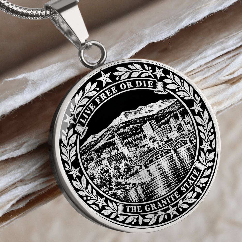 Silver New Hampshire necklace with mountain lake town, Live Free or Die motto and ornate Granite State border