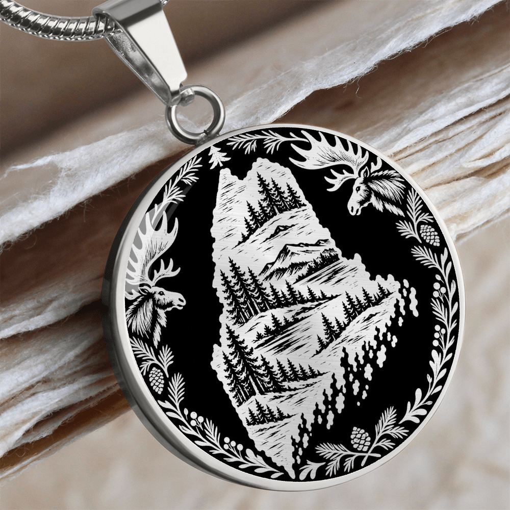 Silver Maine moose necklace featuring Maine state outline with mountain forest landscape, two moose and pinecone woodland border
