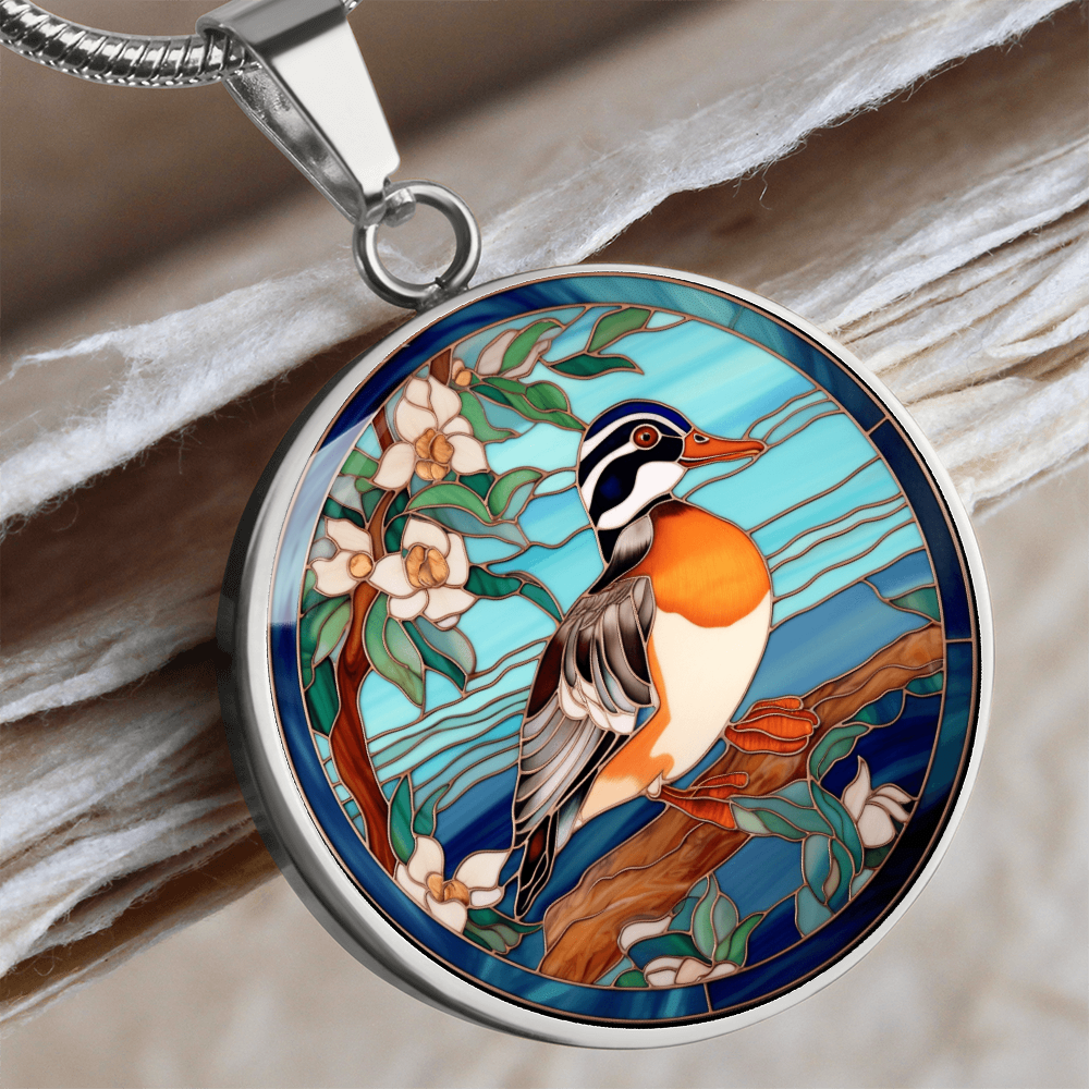 Mandarin duck-inspired necklace featuring a colorful duck perched on a flowering branch against a turquoise-blue stained-glass-style background.