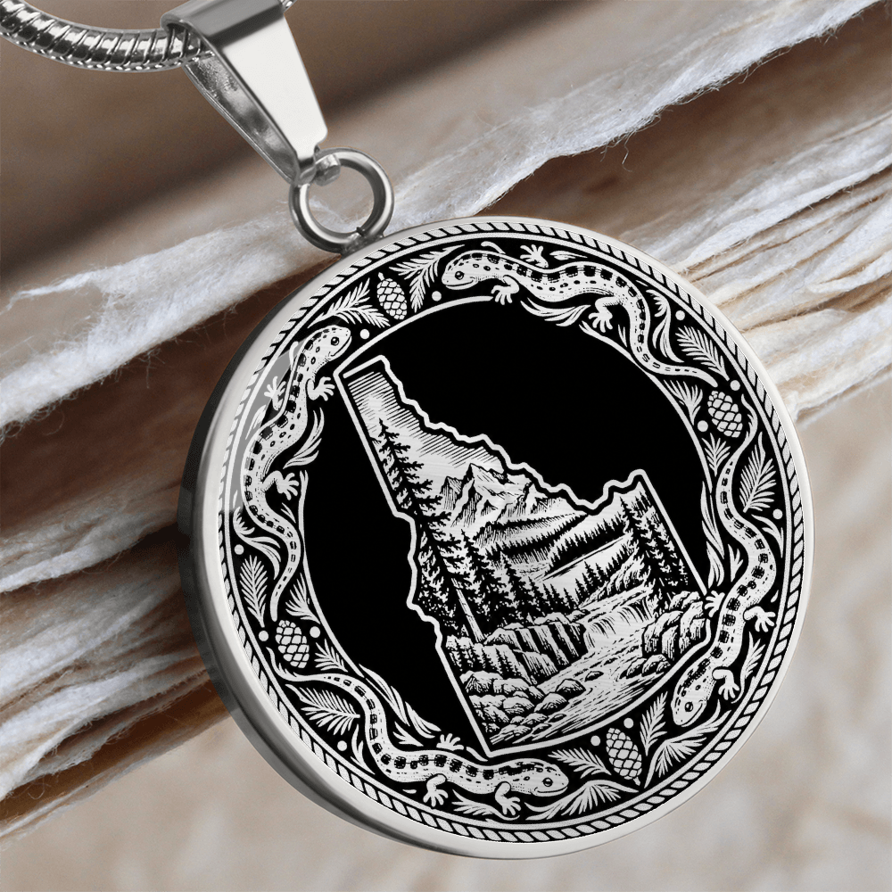 Silver Idaho wilderness necklace with Idaho state outline, mountain forest landscape, river and ornate salamander border