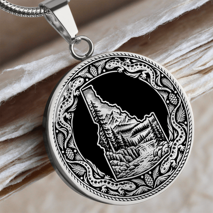 Silver Idaho wilderness necklace with Idaho state outline, mountain forest landscape, river and ornate salamander border