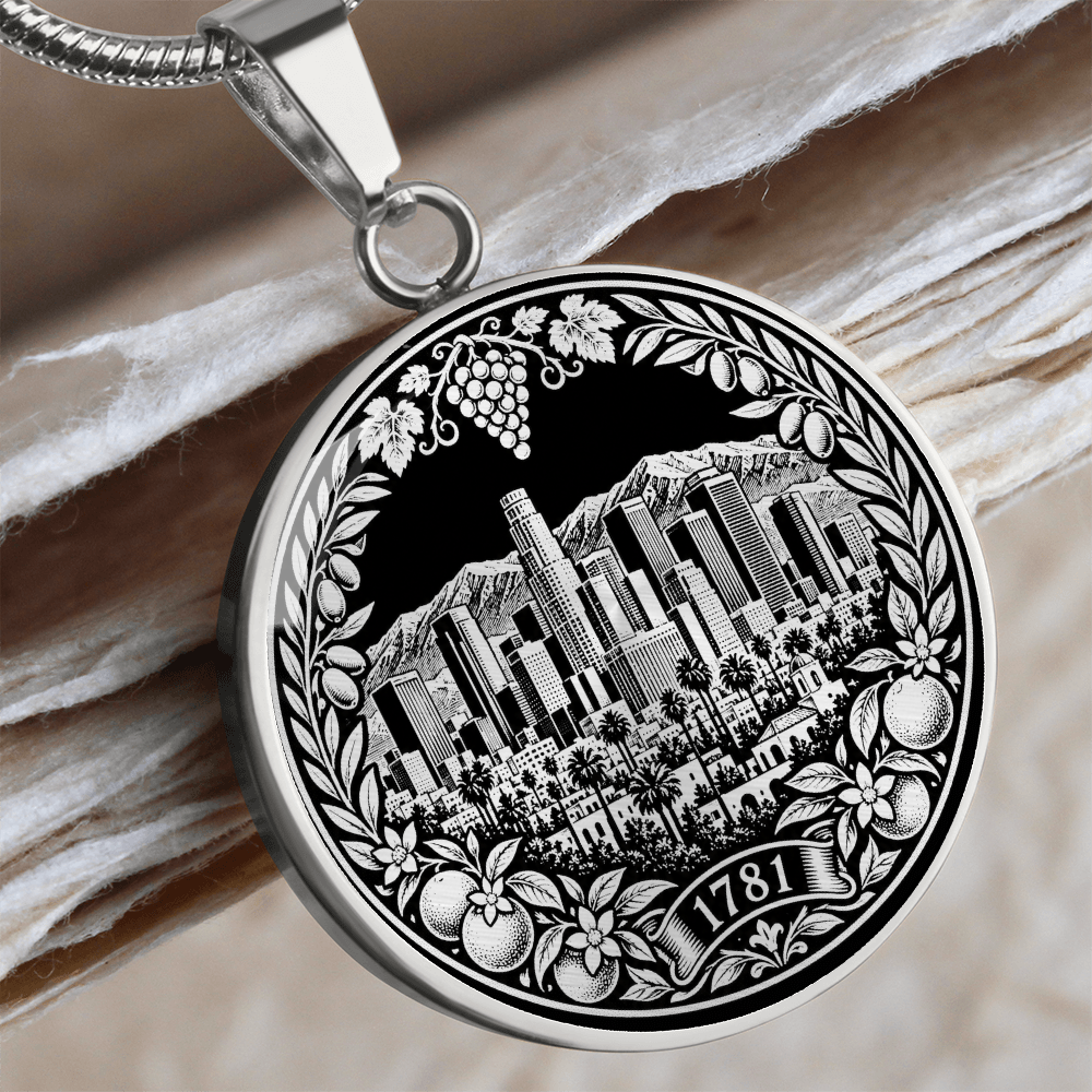 Silver Los Angeles skyline necklace featuring downtown skyscrapers, palm trees, mountains, citrus fruit and 1781 botanical emblem