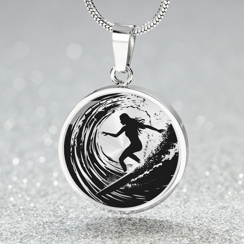 Silver Female surfer necklace featuring a black silhouette of a woman riding inside a curling ocean wave on a round black-and-white pendant.