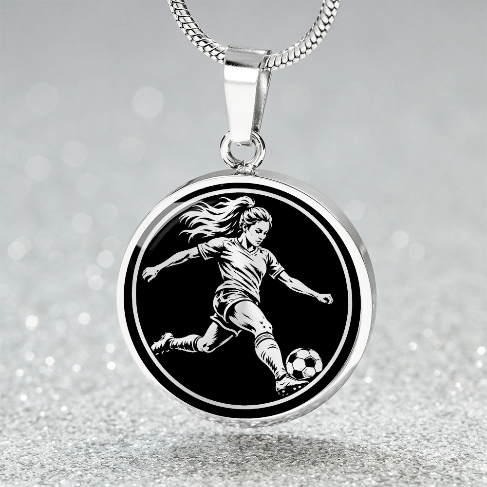 Silver-tone round soccer pendant featuring a female footballer kicking a ball
