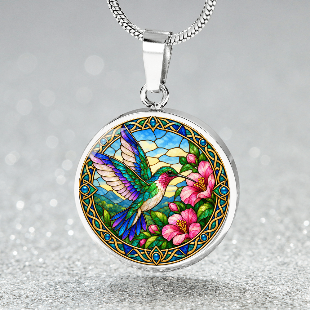 Close-up of hummingbird pendant with detailed wildlife illustration