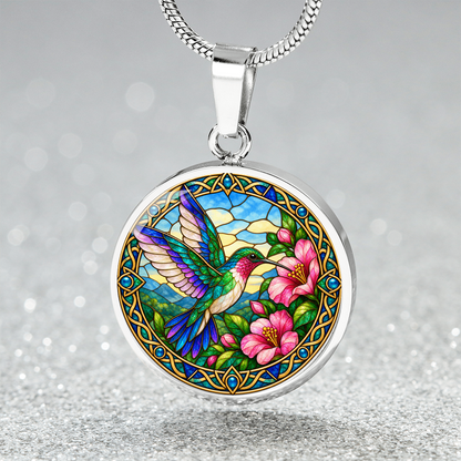 Close-up of hummingbird pendant with detailed wildlife illustration