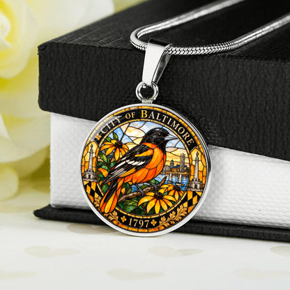 Silver Baltimore Oriole necklace with orange and black stained-glass bird, golden flowers, City of Baltimore lettering and 1797 inscription
