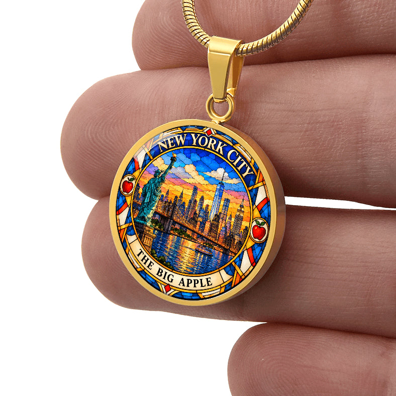 Gold finish NYC skyline pendant necklace with stained glass Manhattan buildings, Statue of Liberty, waterfront and The Big Apple lettering