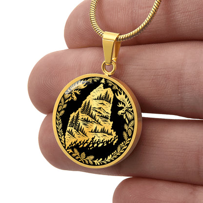 GoldMaine moose necklace featuring Maine state outline with mountain forest landscape, two moose and pinecone woodland border
