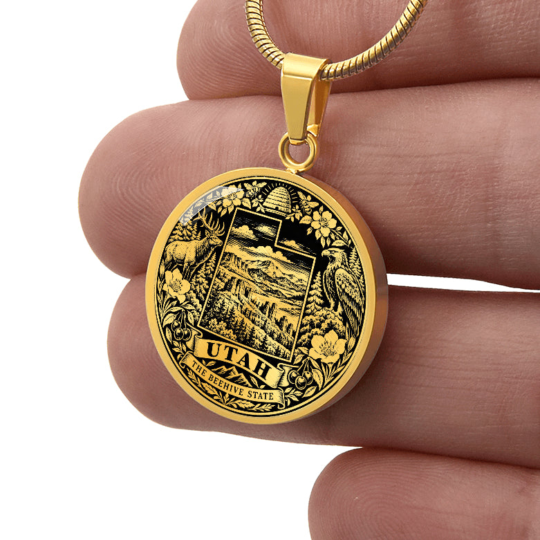 Gold finish Utah Beehive State pendant with stylized state outline, beehive, elk, eagle, mountain scenery and floral border