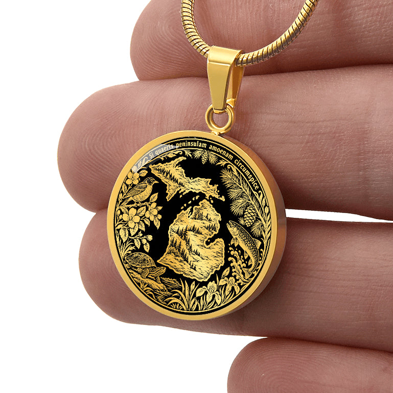 Gold finish Michigan peninsula necklace featuring forest landscapes, wildlife, botanical border and Michigan Latin state motto