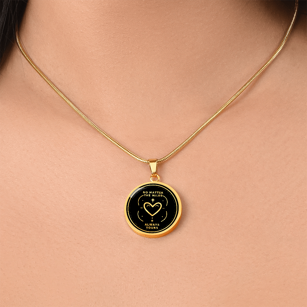 Gold finish No Matter the Miles necklace worn around the neck, featuring a circular black and gold Always Yours heart pendant.