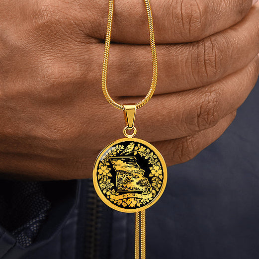 Gold finish Missouri State pendant featuring woodland landscape inside Missouri map silhouette, perched bird, flowers and state motto
