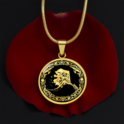 Gold finish Alaska mountain necklace with dramatic snowy peak illustration, black and gold linocut design and decorative border.
