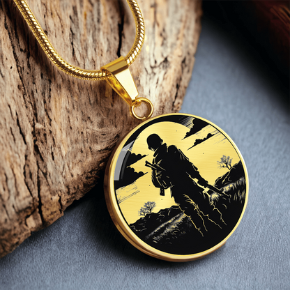 Gold Soldier silhouette necklace with black-and-white illustration of an armed service member walking through a rugged landscape on a round pendant.