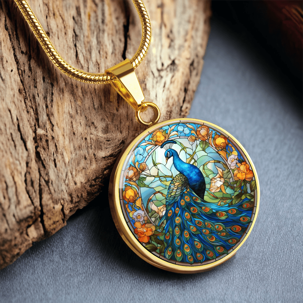 Gold finish peacock necklace displaying vivid blue peacock artwork and decorative flowering branches.