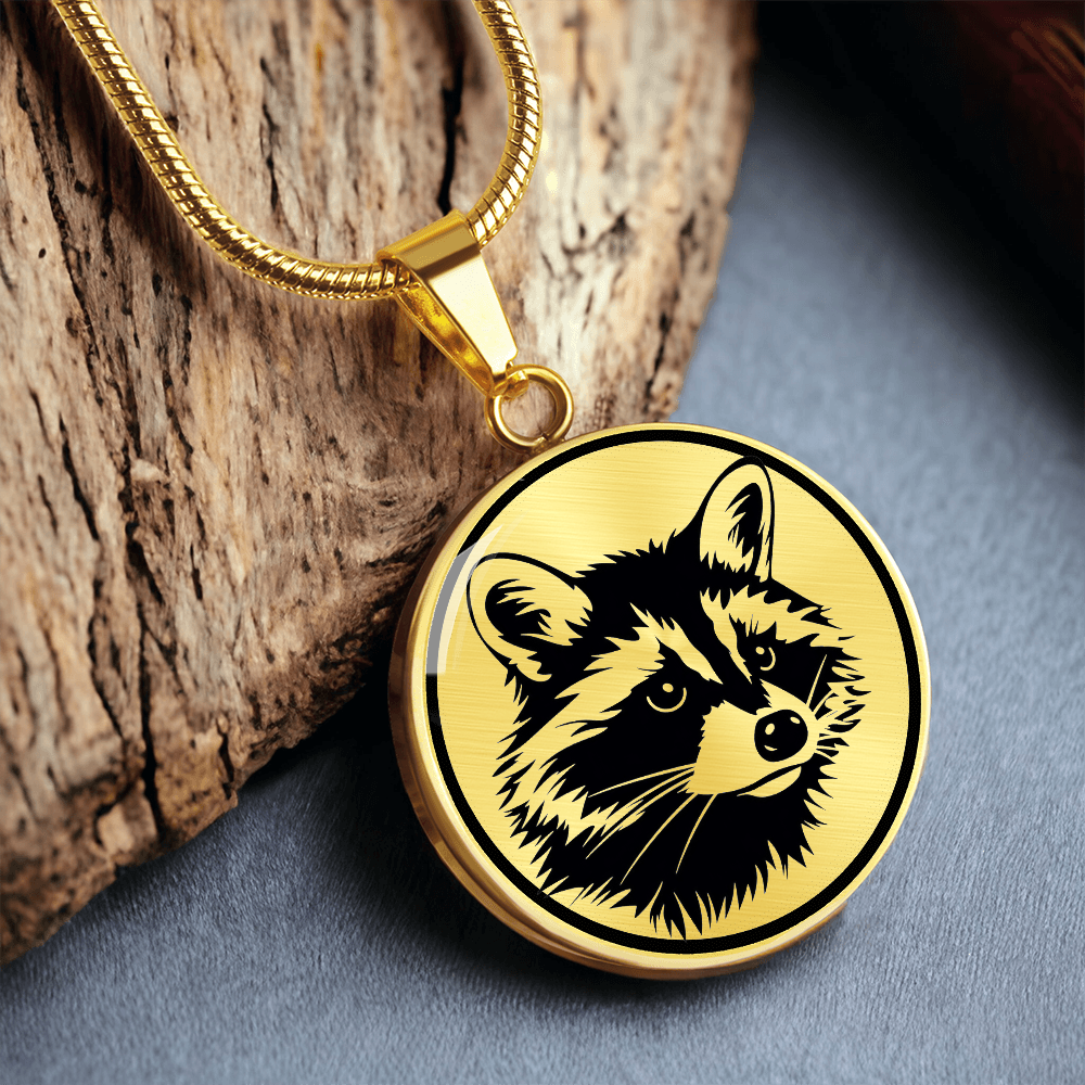 Raccoon necklace featuring a bold black-and-white raccoon face illustration with pointed ears and distinctive eye mask on a round silver-colored pendant.
